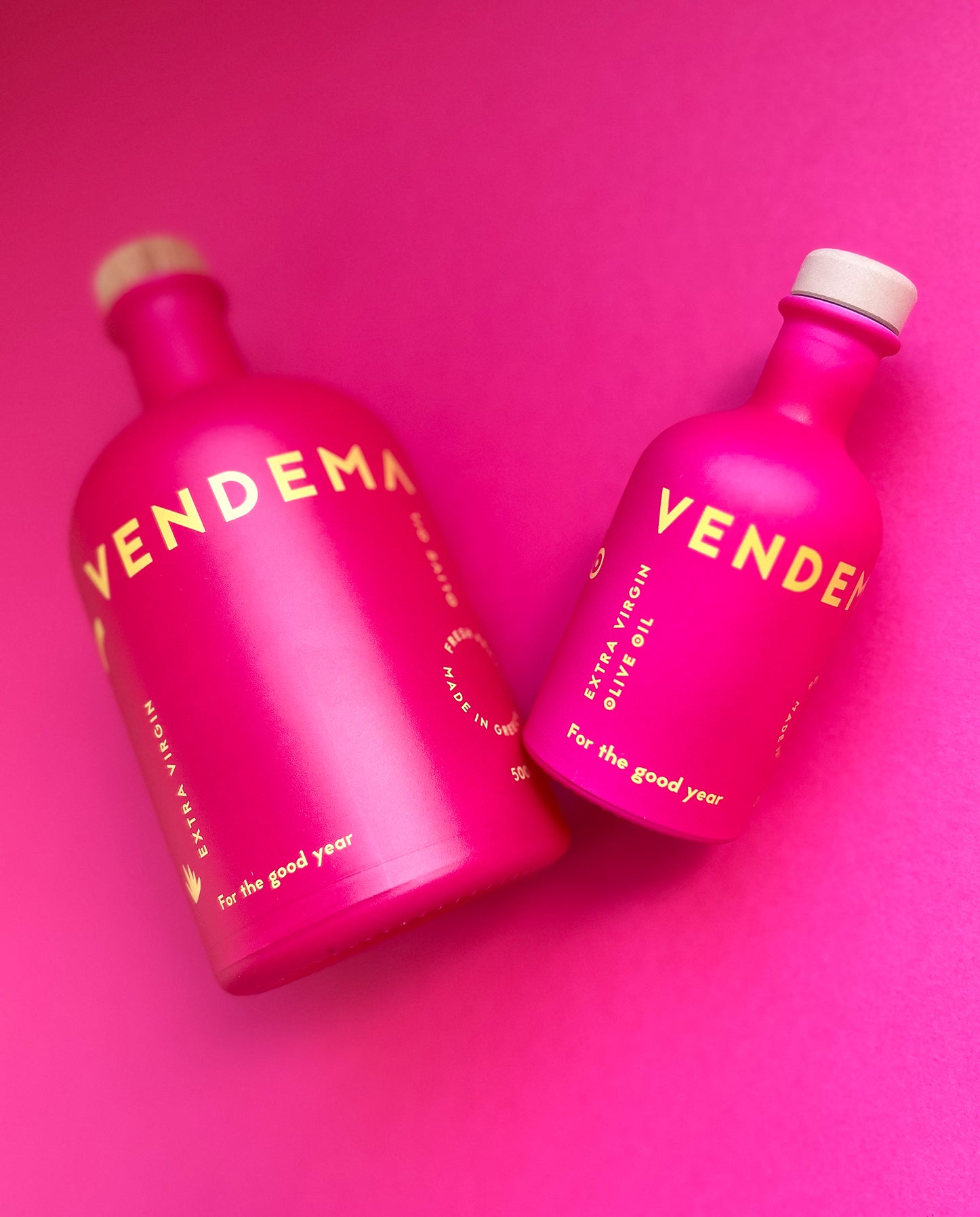 Details of Vendema Extra Virgin Olive Oil Bottles in Pink Background.