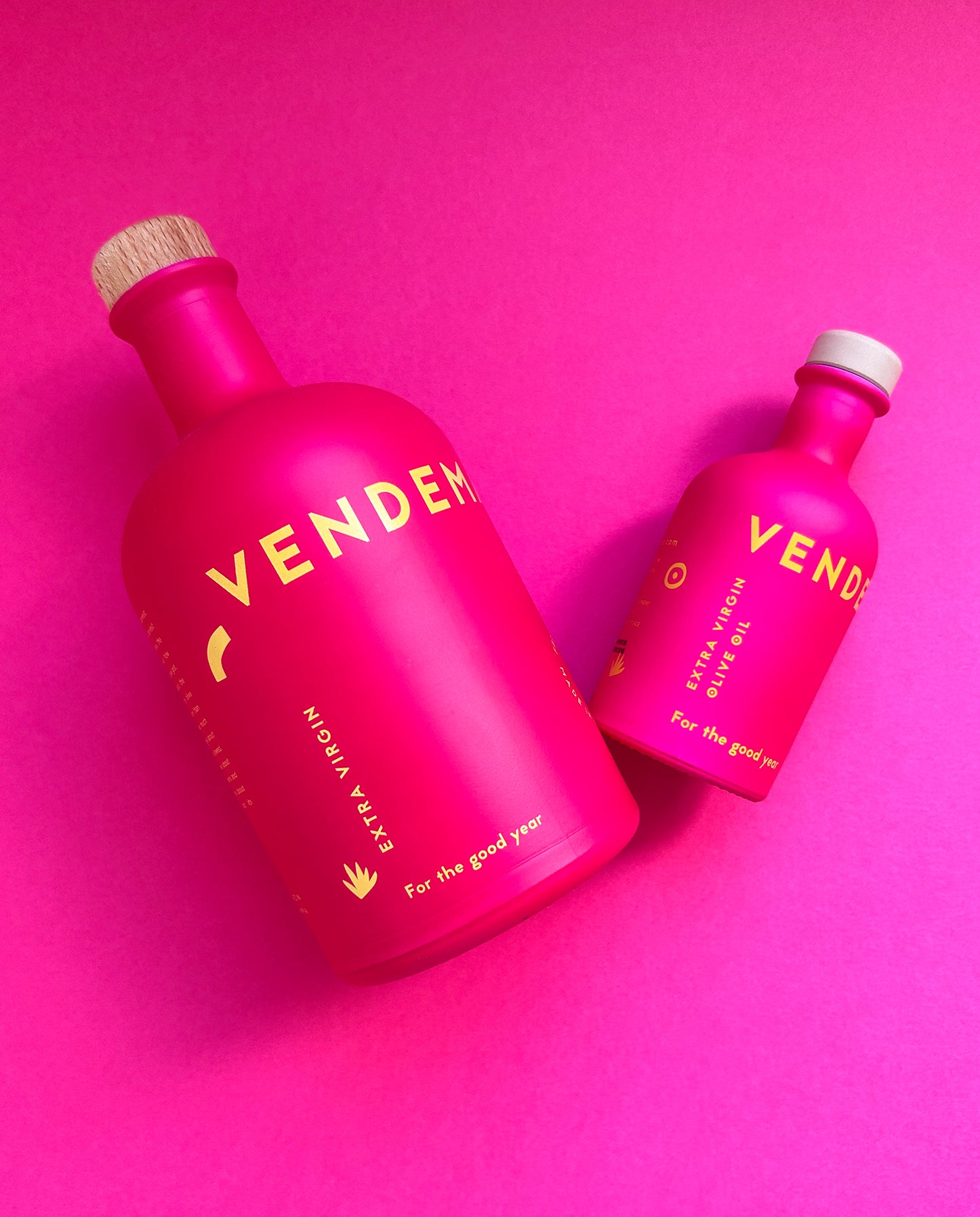 Details of Vendema Extra Virgin Olive Oil Bottles in Pink Background.