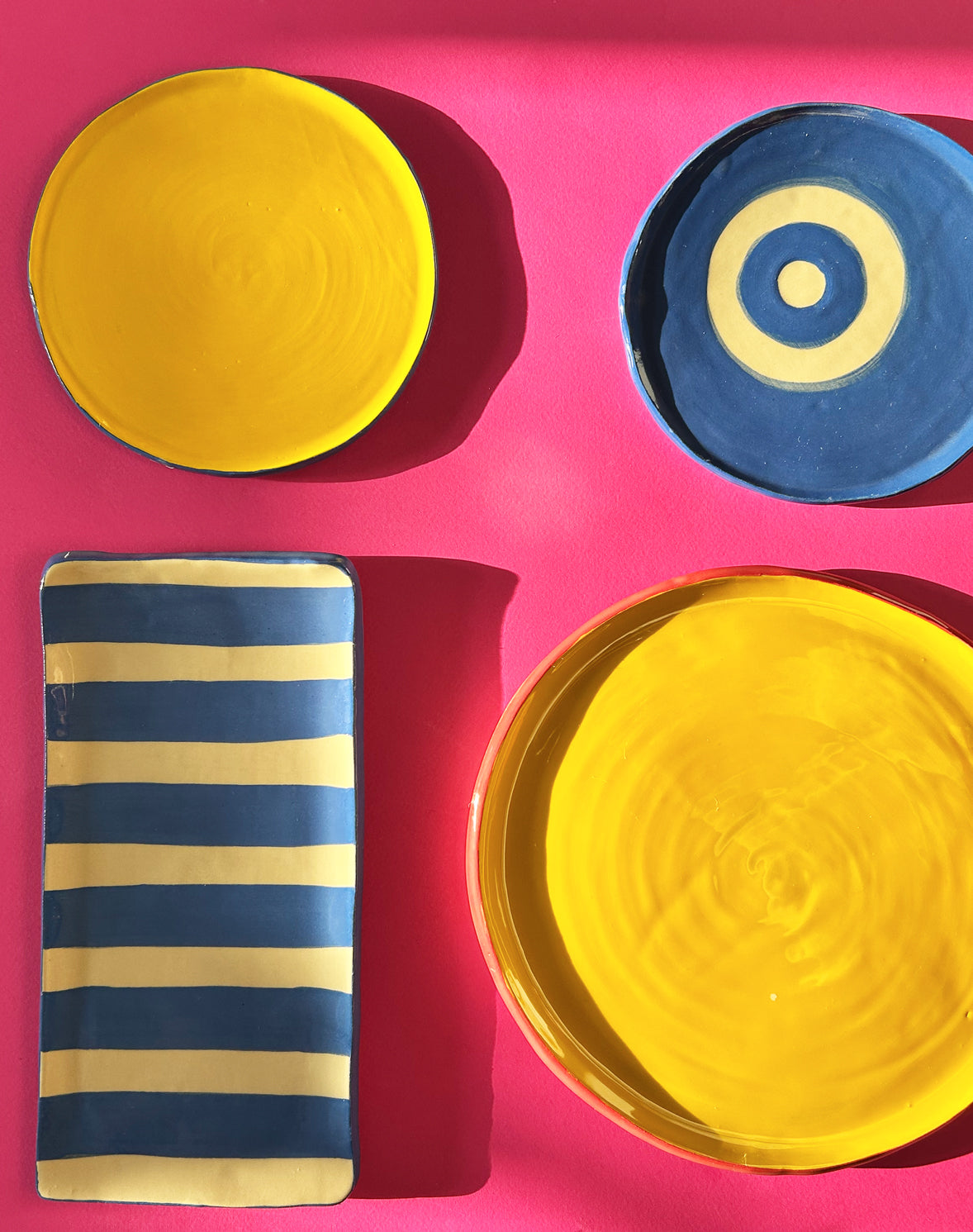 View from above of colourful ceramic plates and platter.