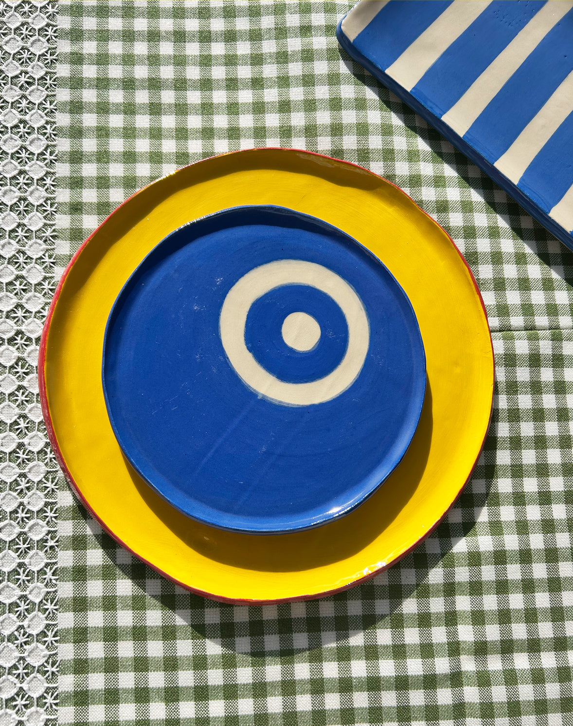 View from above of colourful ceramic plates and platters.