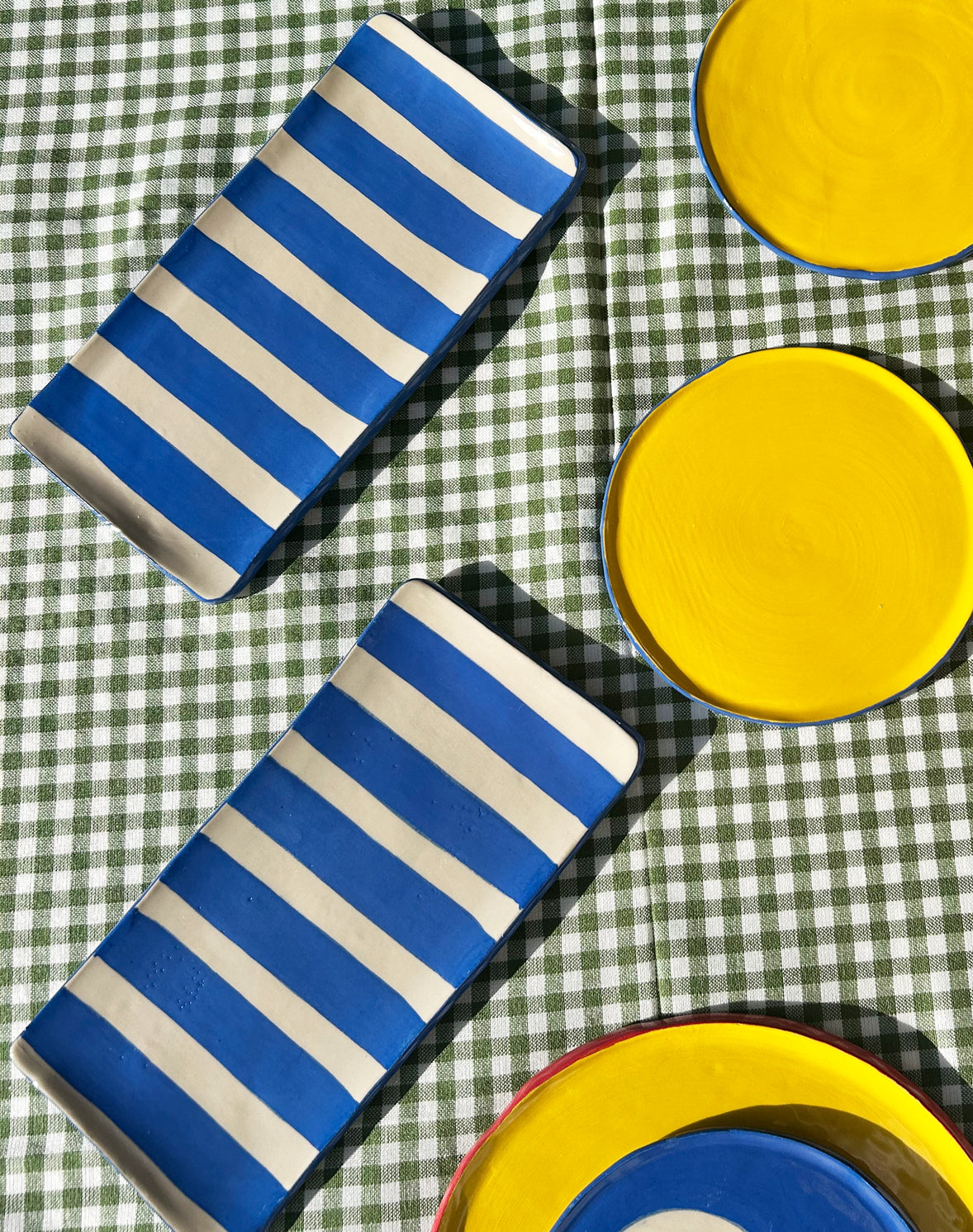 View from above of colourful ceramic plates and platters.