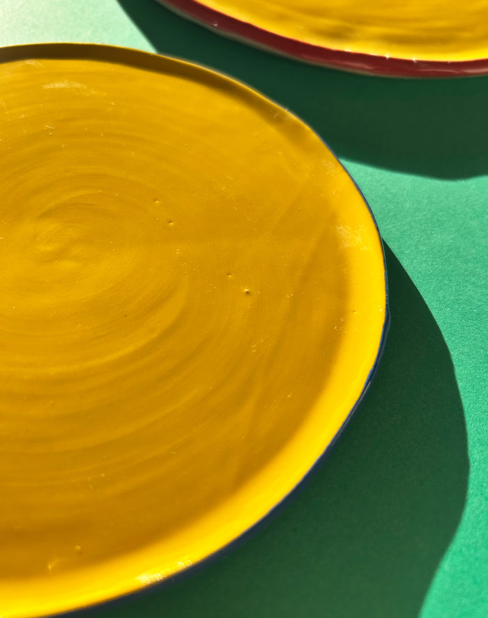 Close-up from above of yellow ceramic salad plate.