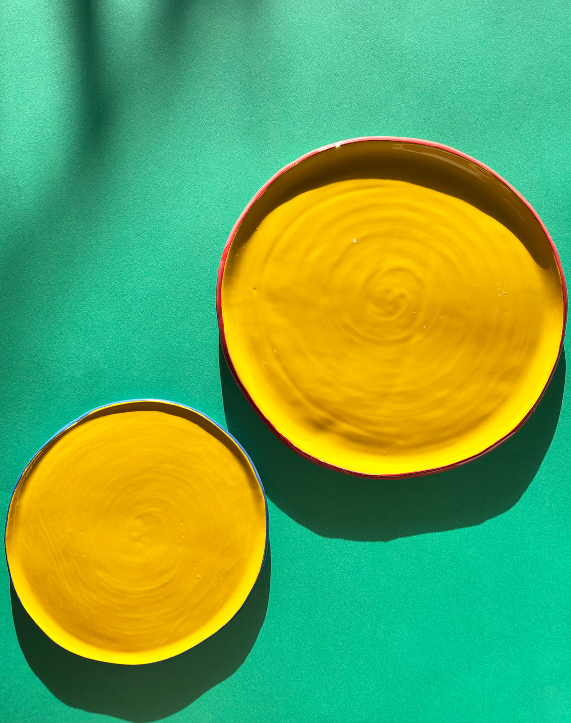 View from above of two yellow ceramic salad plates.