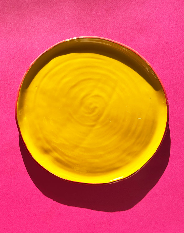 View from above of yellow ceramic dinner plate.