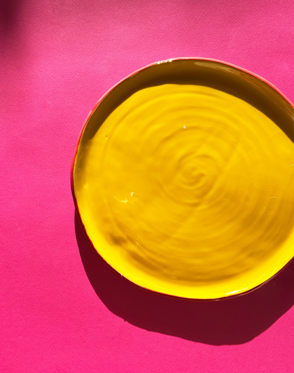 View from above of yellow ceramic dinner plate.